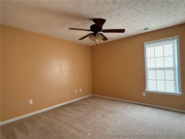 a spacious bathroom with a shower a sink and a toilet