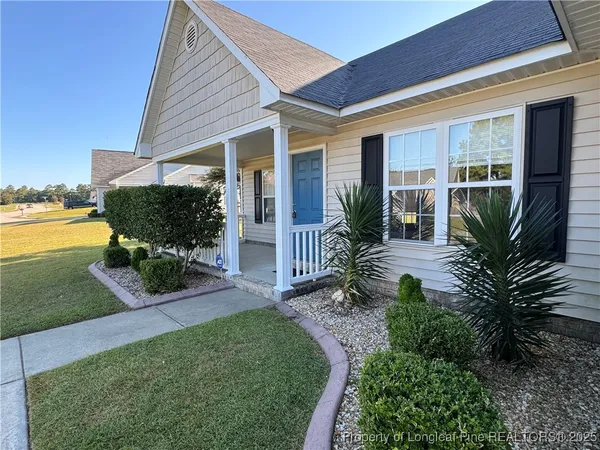 a front view of a house with garden