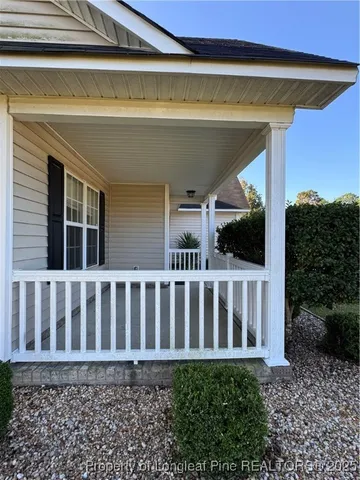 a view of a house with wooden fence