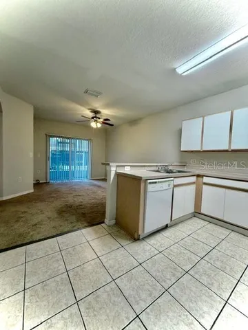 a kitchen with a stove a sink and a refrigerator