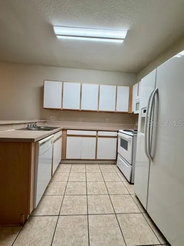 a kitchen with a stove a sink and a refrigerator