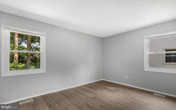 an empty room with wooden floor and closet