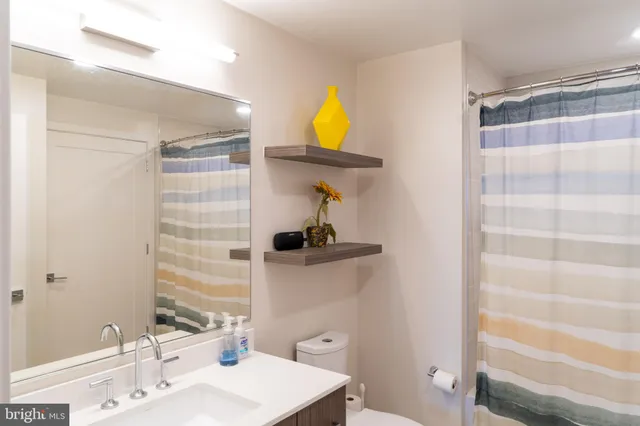 a bathroom with a sink a mirror and a shower