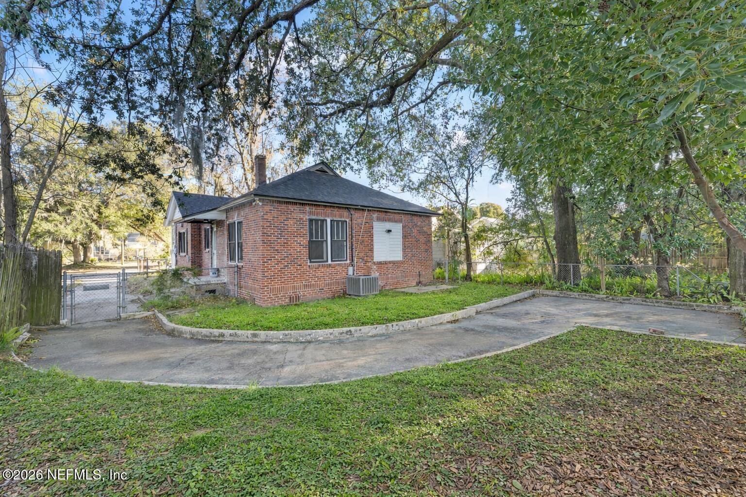 449 Sunset Drive Jacksonville, FL 32208 - Photo 29 of 31 Backyard with red brick house and trees