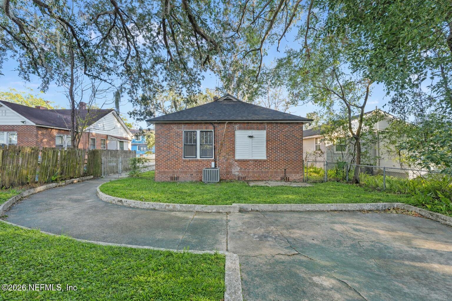 449 Sunset Drive Jacksonville, FL 32208 - Photo 30 of 31 Backyard with red brick house