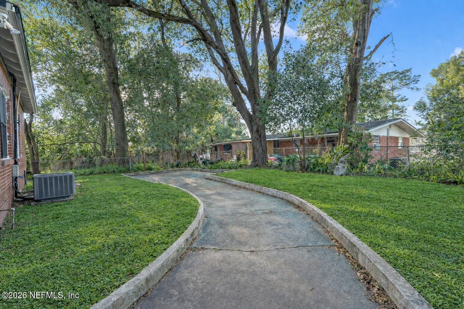 449 Sunset Drive Jacksonville, FL 32208 - Photo 31 of 31 Sunny backyard pathway with lush greener