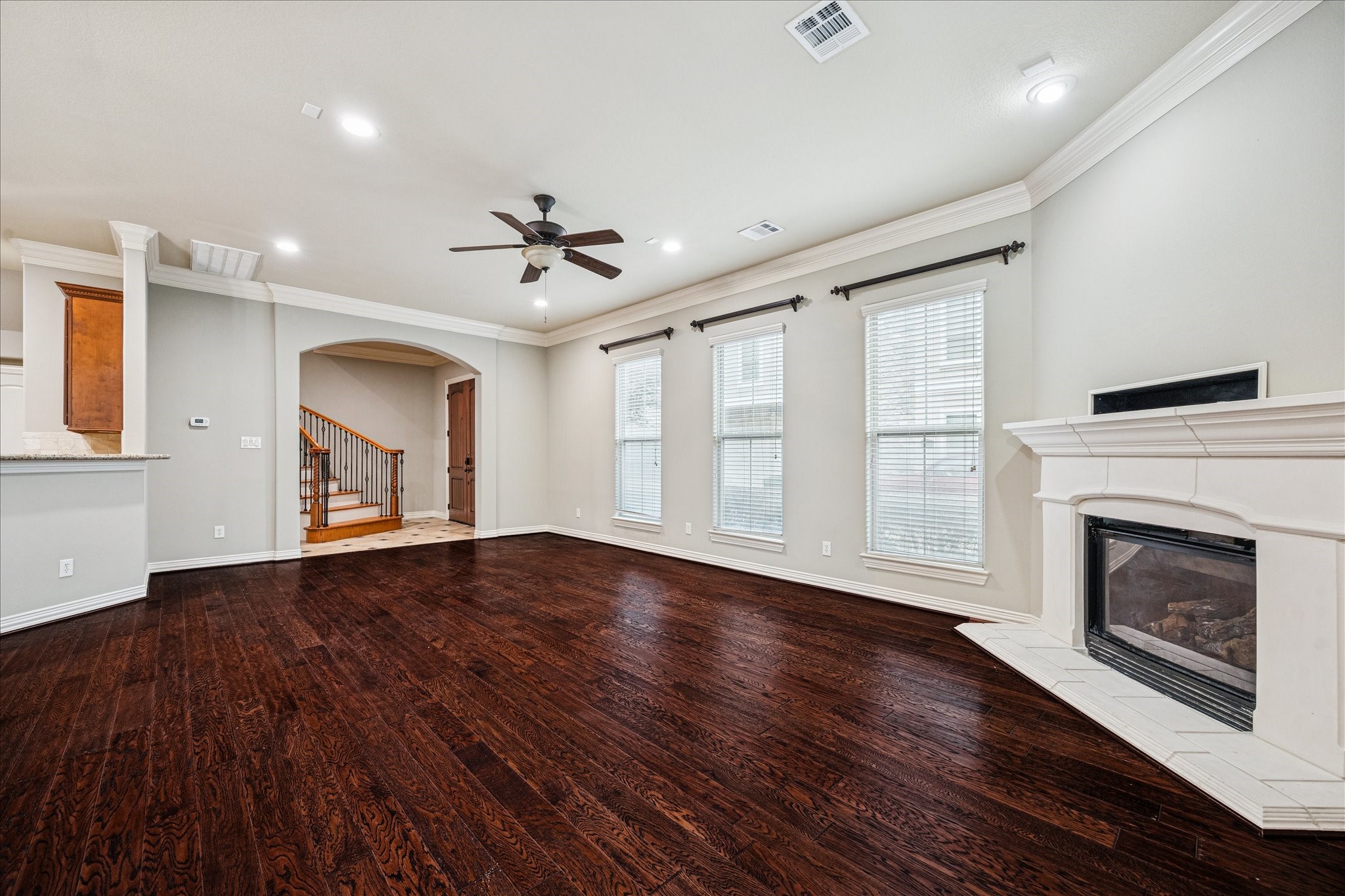 2 Schwab Lane Houston, TX 77055 - Photo 23 of 27 an empty room with wooden floor fireplace and windows