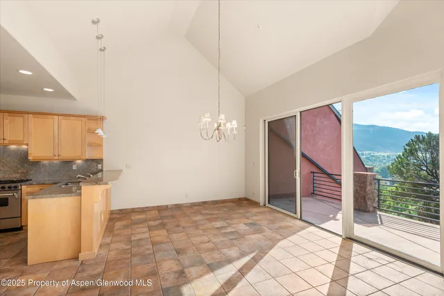 a view of a livingroom with a furniture and floor to ceiling window