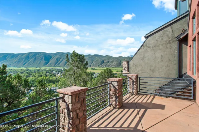 a view of a roof deck with couches and wooden floor