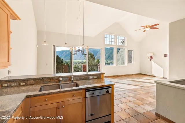 a view of a kitchen with a sink and large window