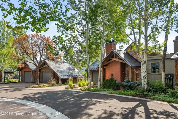 a view of a house with a tree and a big yard