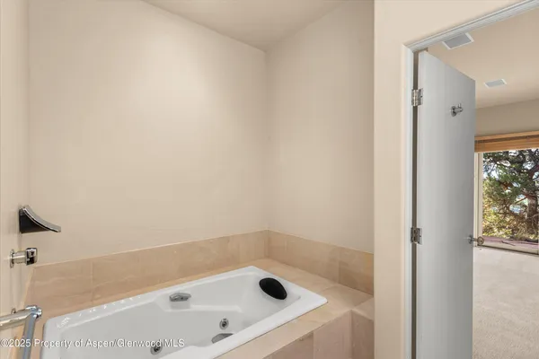 a bathroom with a tub and shower
