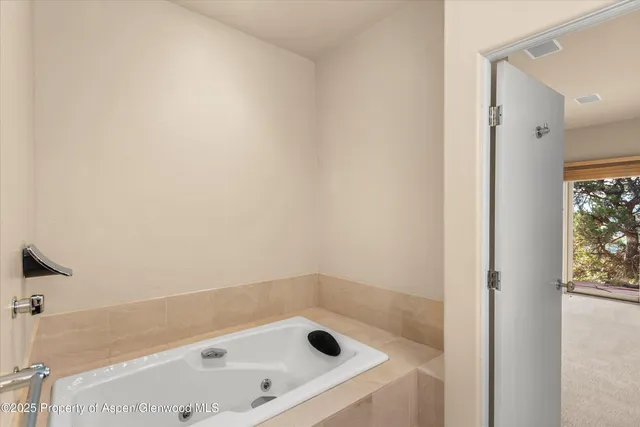 a bathroom with a tub and shower