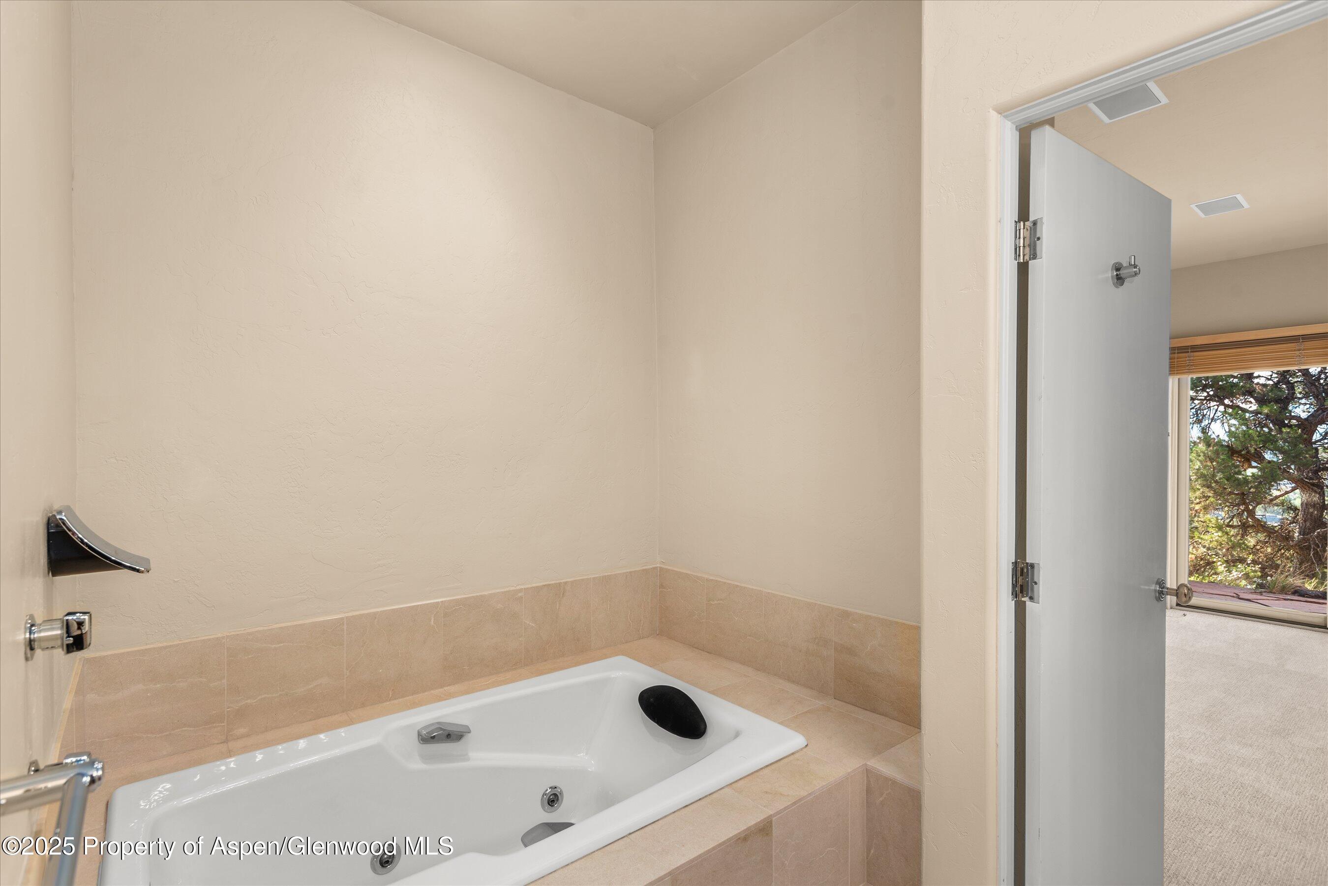 404 Wild Spring Lane Basalt, CO 81621 - Photo 23 of 30 a bathroom with a tub and shower