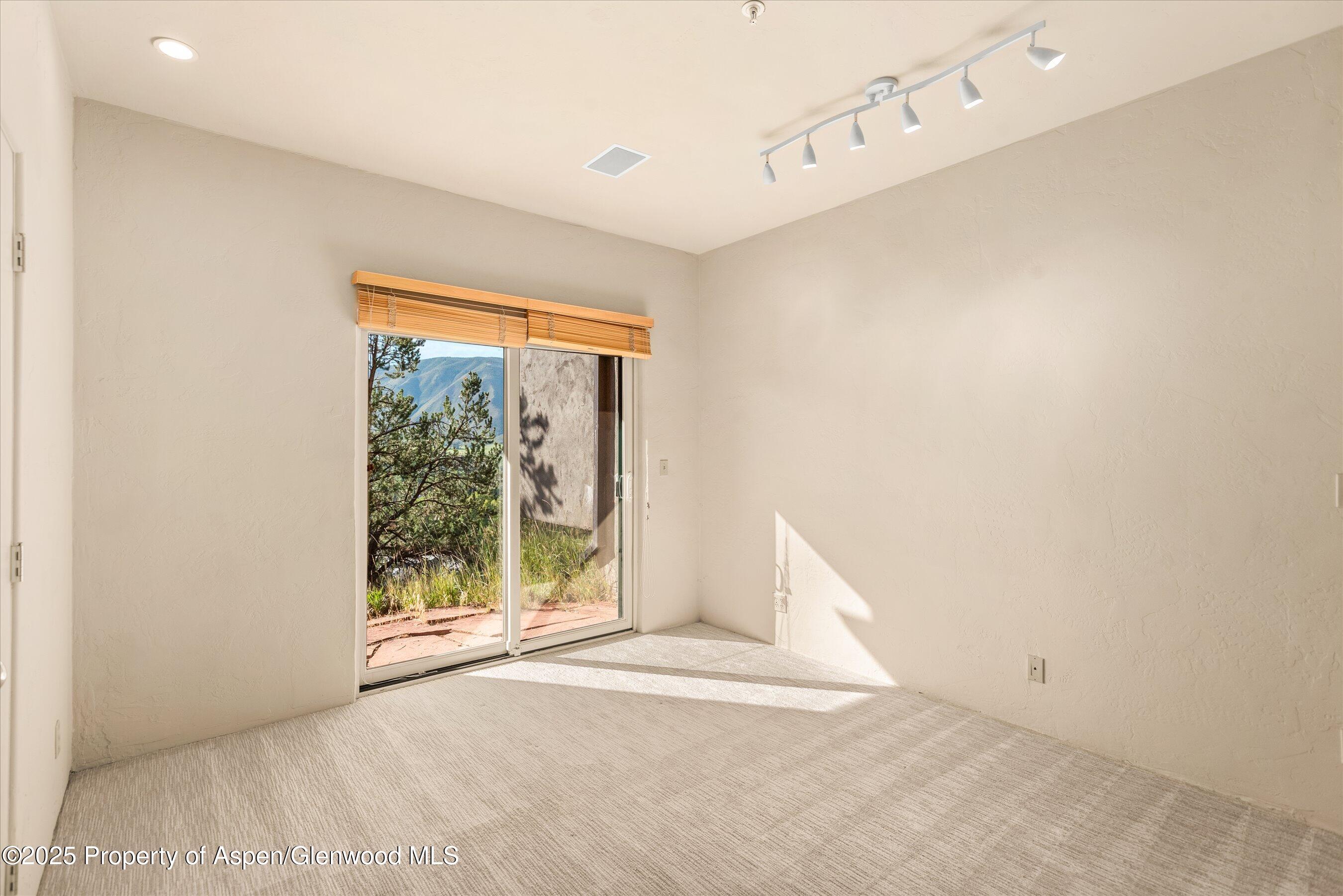 404 Wild Spring Lane Basalt, CO 81621 - Photo 25 of 30 a view of an empty room with wooden floor and a window