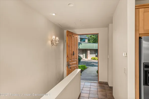 a view of a hallway view with wooden floor and living room