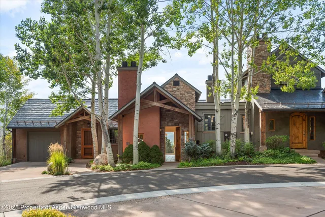 a front view of a house with a tree in a patio