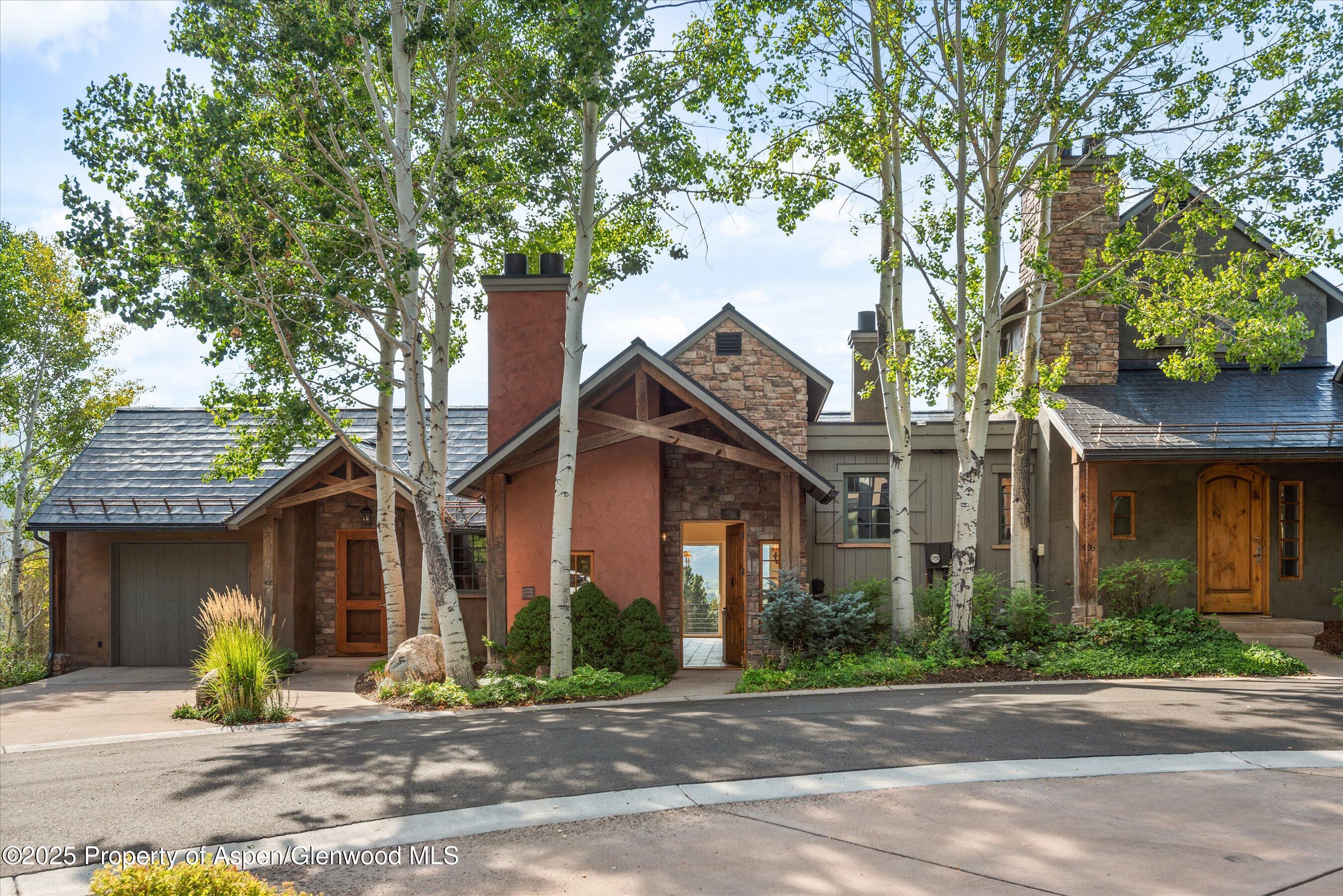 404 Wild Spring Lane Basalt, CO 81621 - Photo 5 of 30 a front view of a house with a tree in a patio