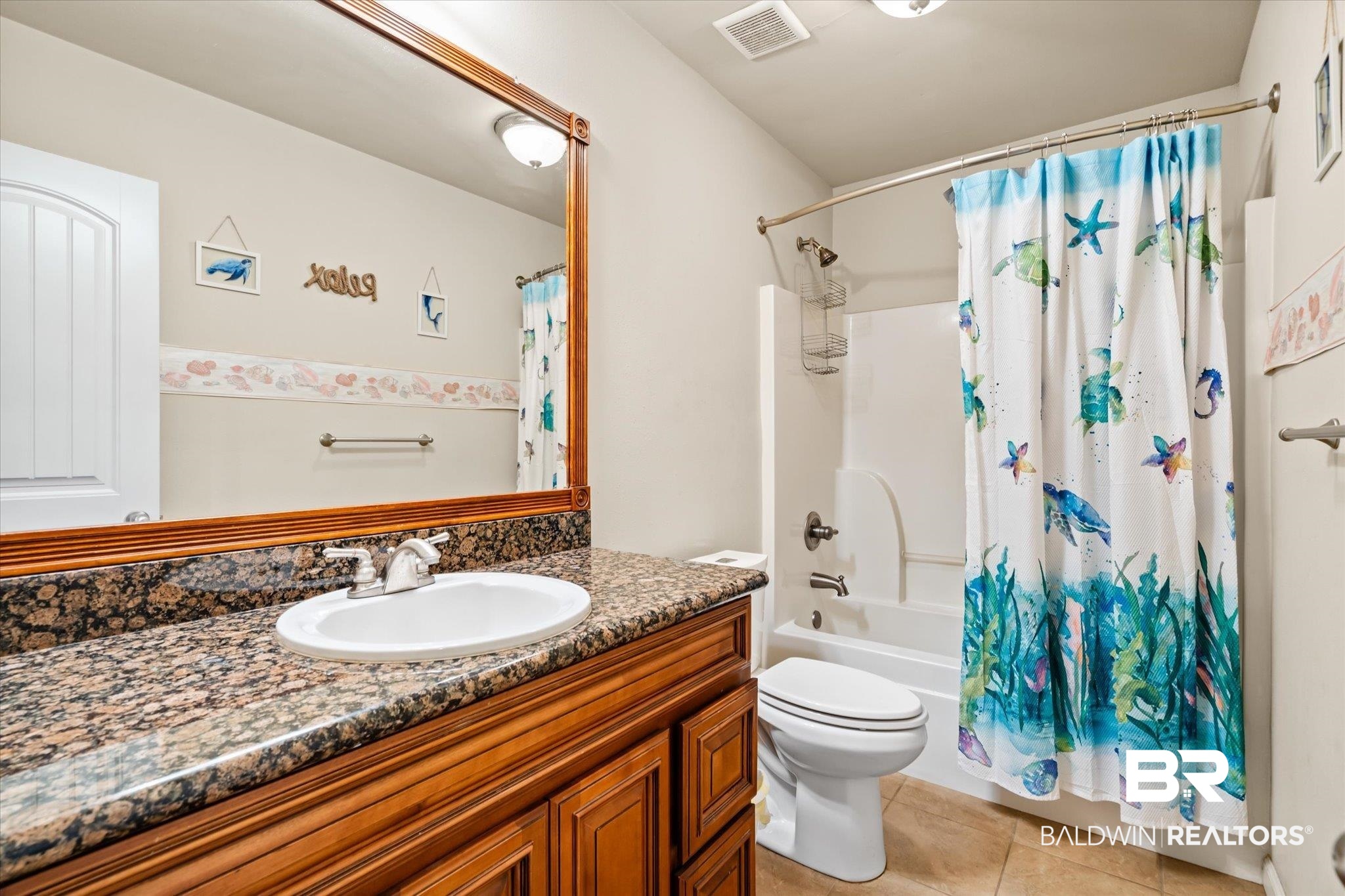 2855 Rebecca Drive West Mobile, AL 36618 - Photo 15 of 22 Full bathroom with tile patterned flooring, shower / tub combo, vanity, and toilet