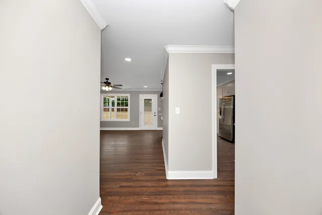 a view of a hallway with wooden floor