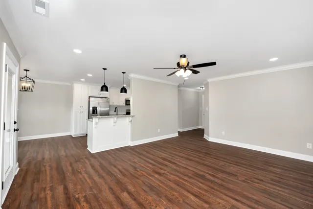 a view of empty room with wooden floor