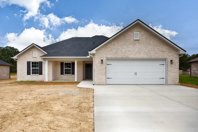 a view of a house with a yard and garage