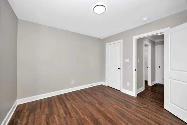 a view of a room with wooden floor