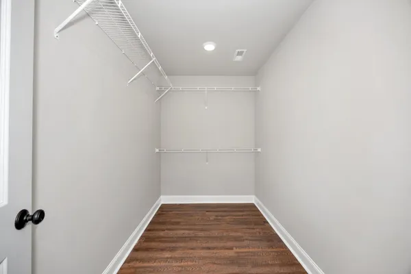 a view of a room with wooden floor