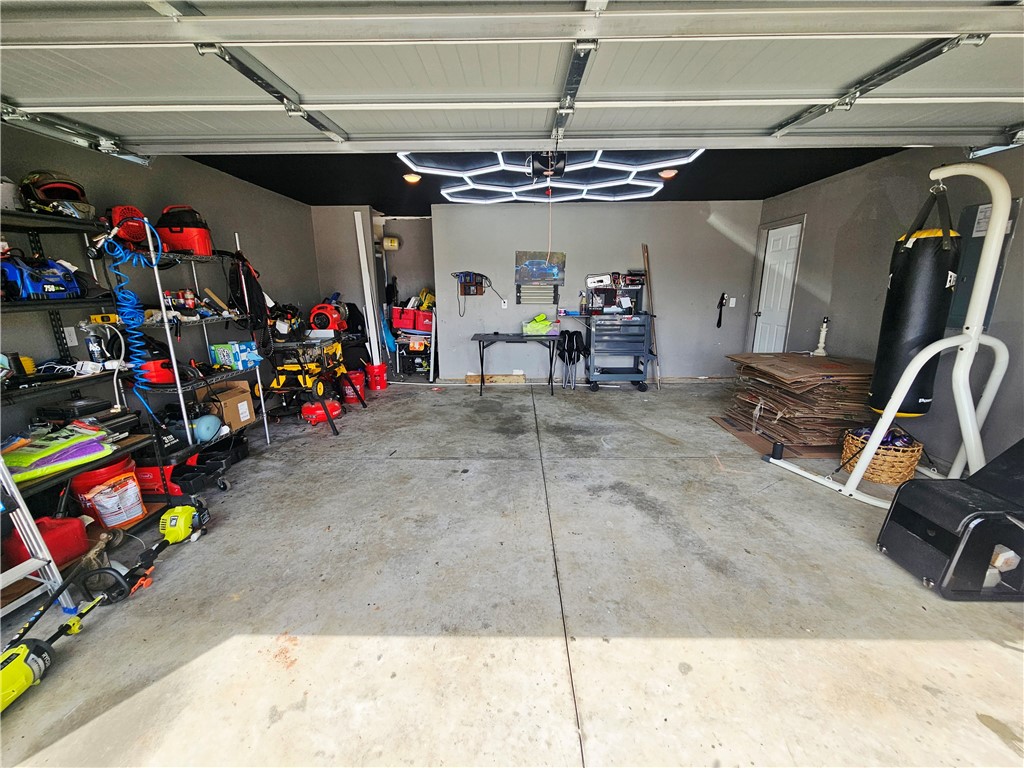 902 Ashwood Lane Easley, SC 29640 - Photo 7 of 39 Ample garage space for parking and projects, featuring convenient storage and a dedicated workspace.