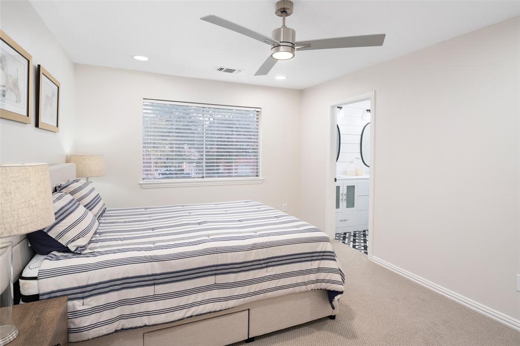 14604 Hemingway Court Addison, TX 75001 - Photo 17 of 27 a bedroom with a bed and a chandelier