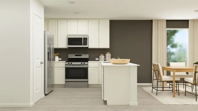 a kitchen with a stove a sink and a microwave