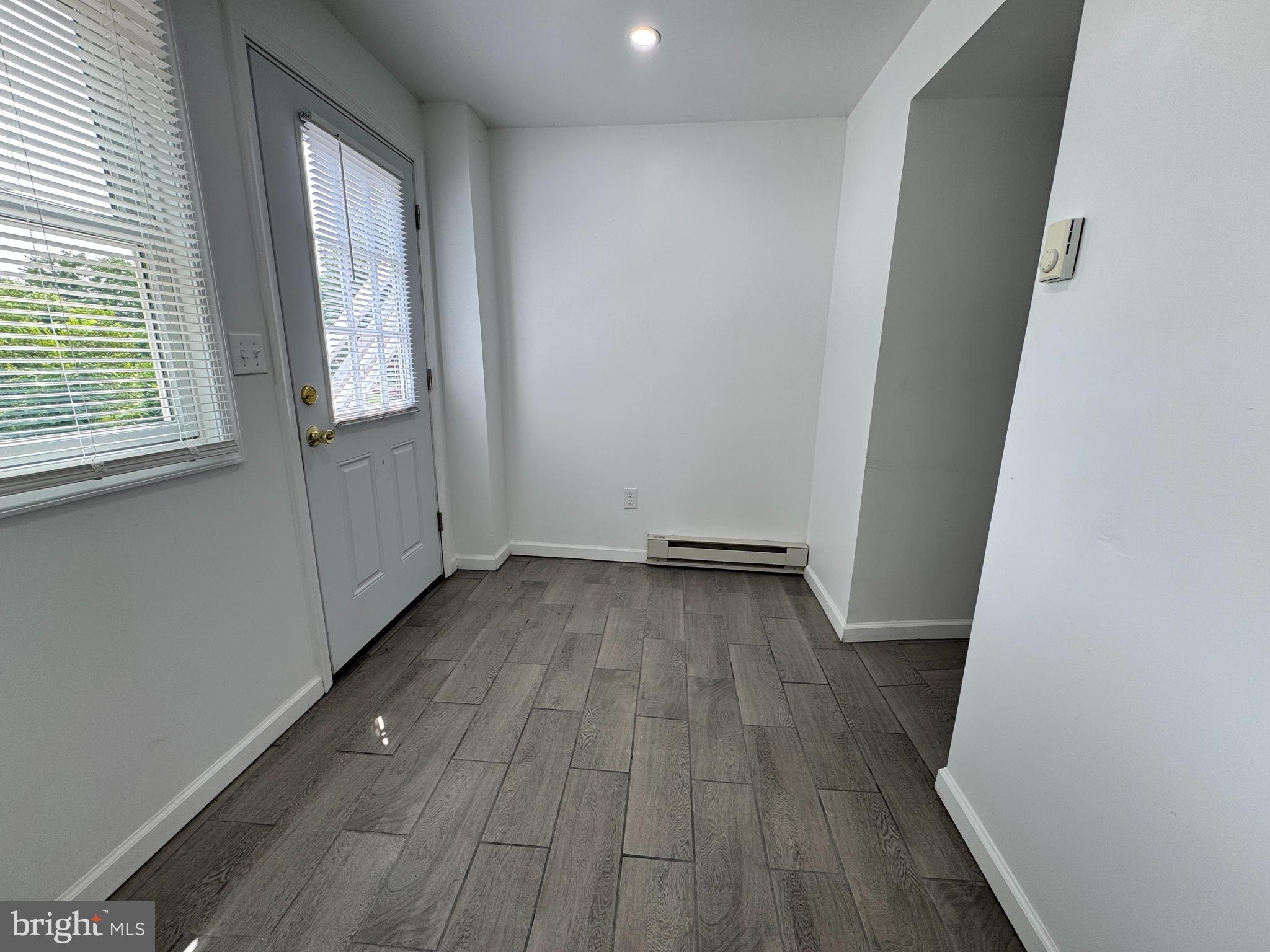 5667 Old York Road, Unit 12 New Hope, PA 18938 - Photo 13 of 17 an empty room with wooden floor and windows