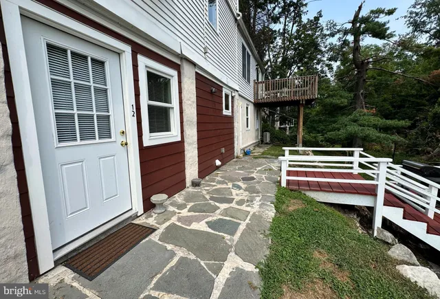 a backyard of a house with wooden floor and fence