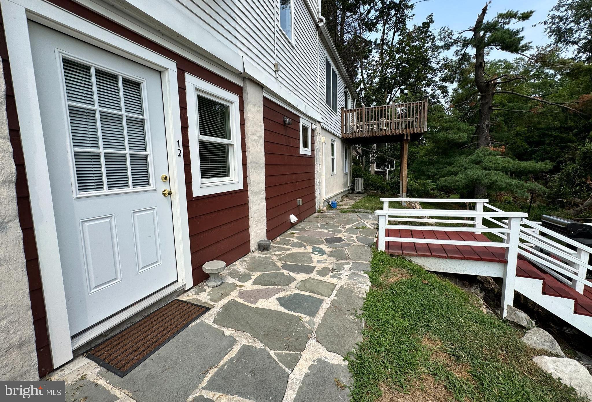 5667 Old York Road, Unit 12 New Hope, PA 18938 - Photo 2 of 17 a backyard of a house with wooden floor and fence