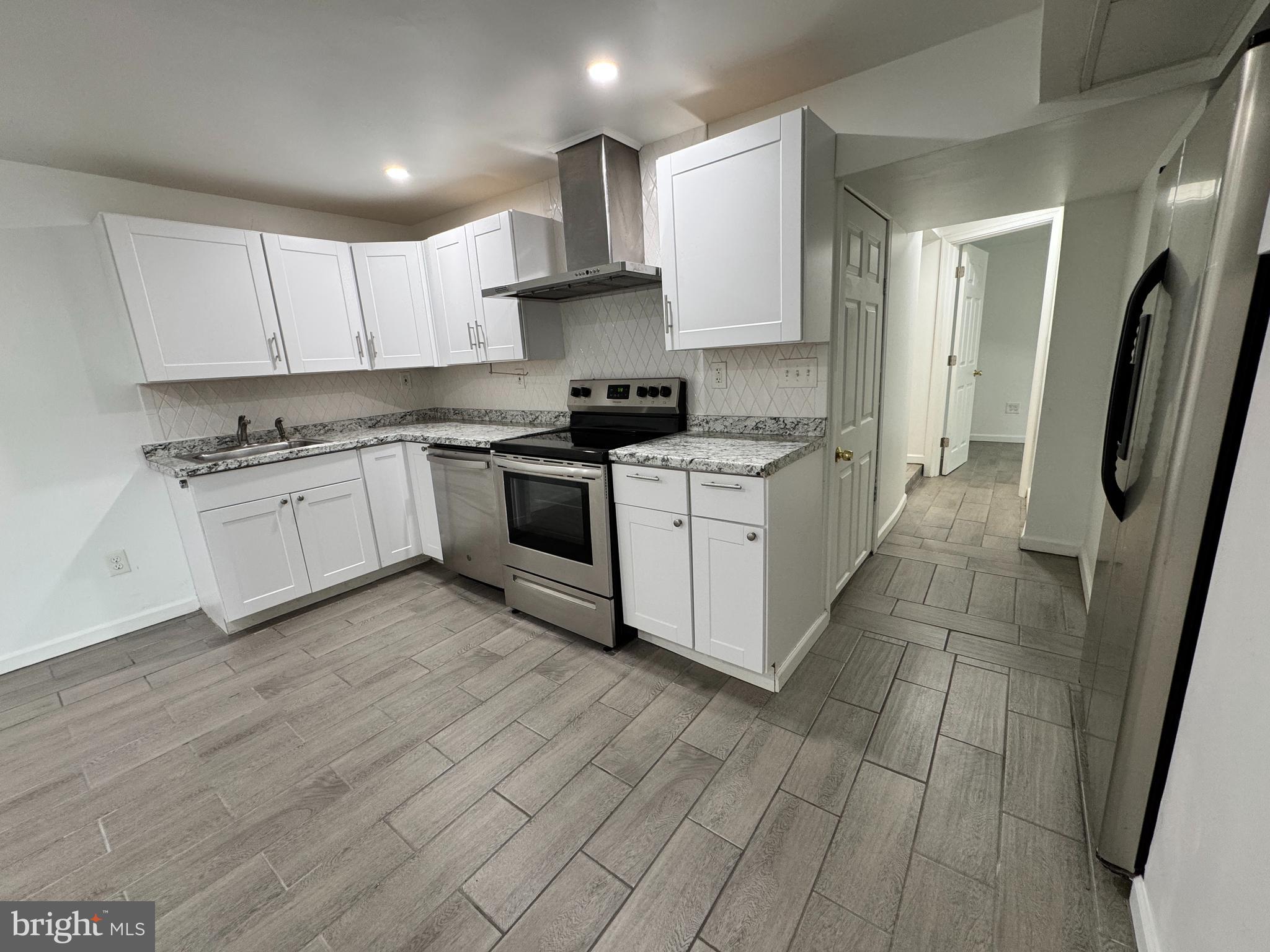5667 Old York Road, Unit 12 New Hope, PA 18938 - Photo 3 of 17 a kitchen with stainless steel appliances granite countertop a stove a sink and a refrigerator