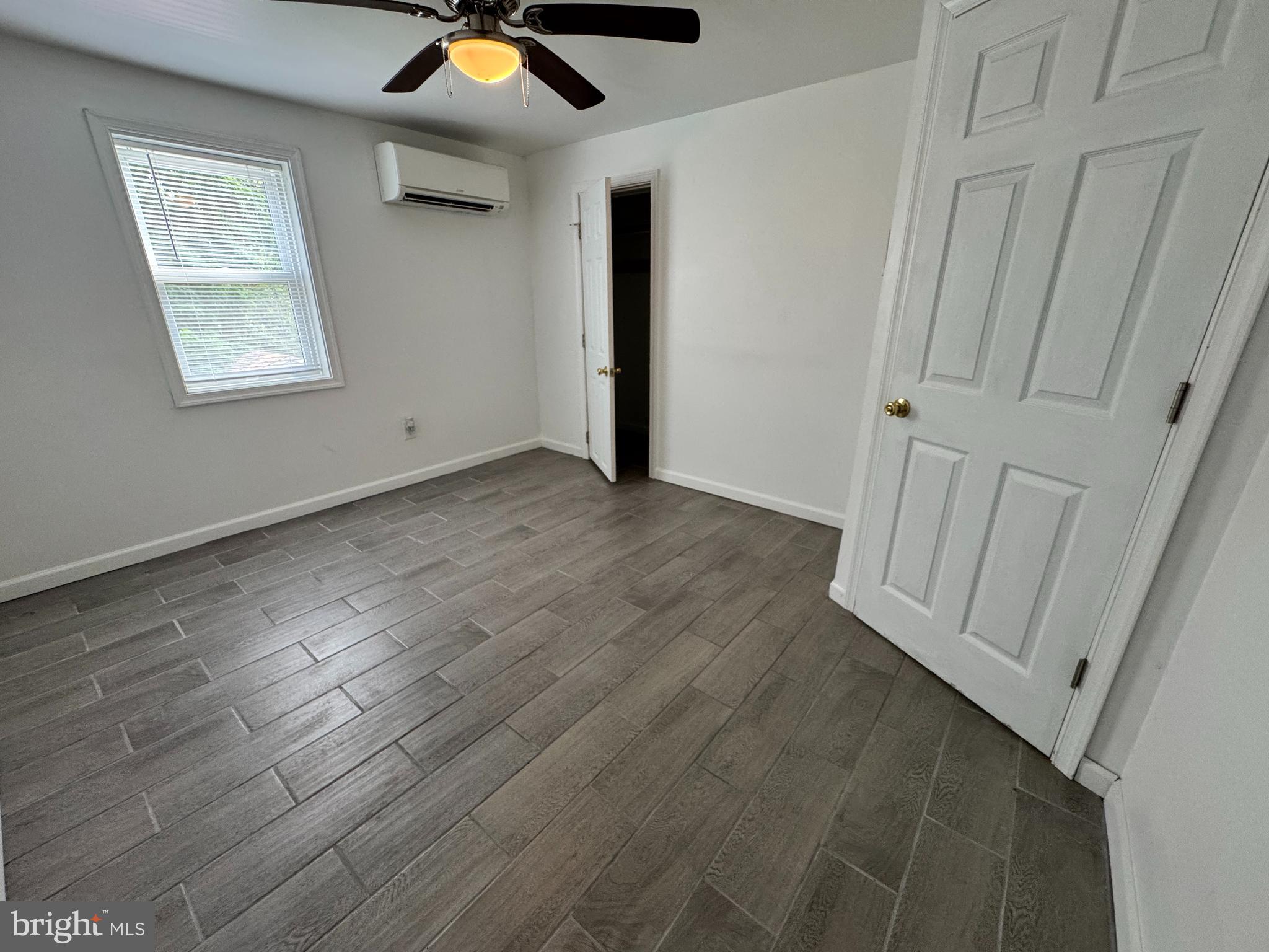 5667 Old York Road, Unit 12 New Hope, PA 18938 - Photo 9 of 17 an empty room with wooden floor and windows