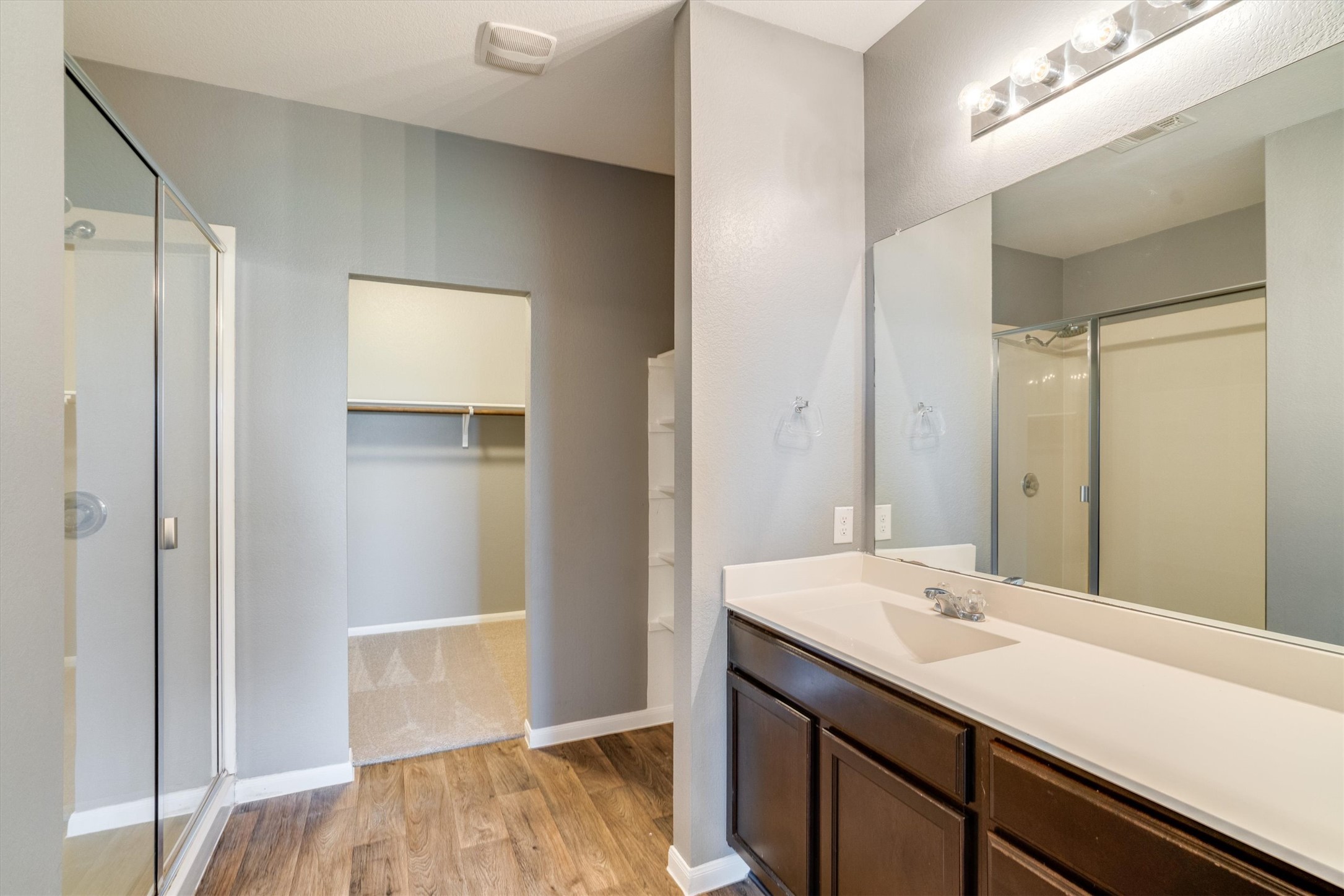 15128 Shell Bark Cove Austin, TX 78724 - Photo 12 of 25 A well-appointed bathroom offers a convenient shower, vanity, and direct closet access.