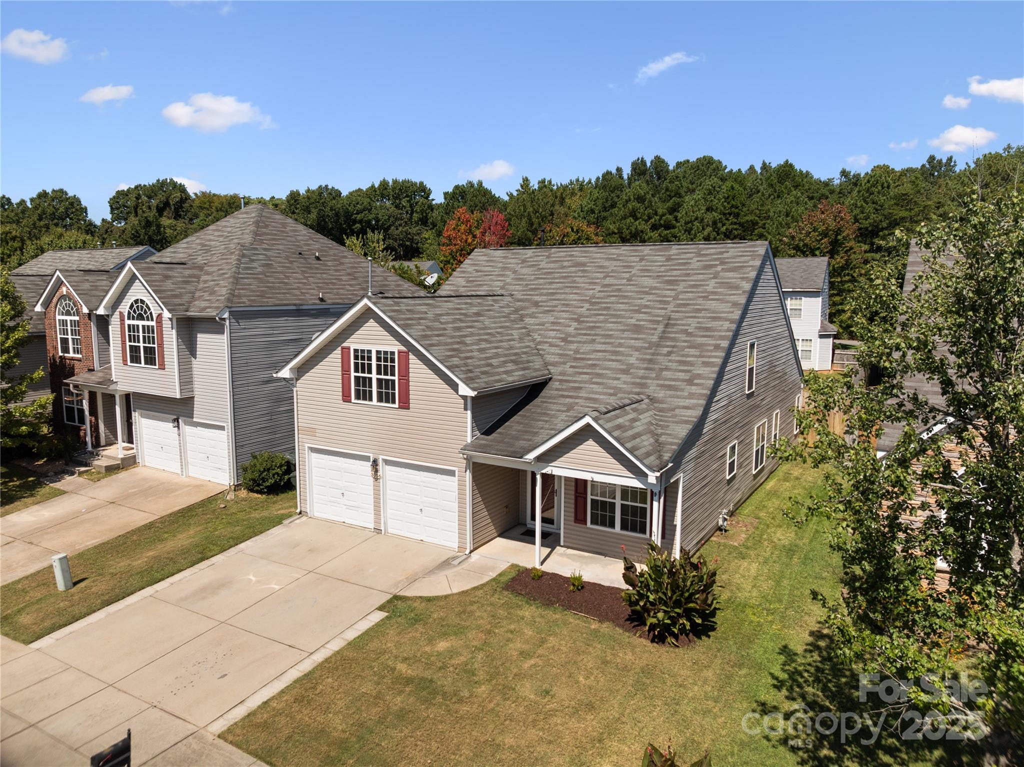 a aerial view of a house next to a yard