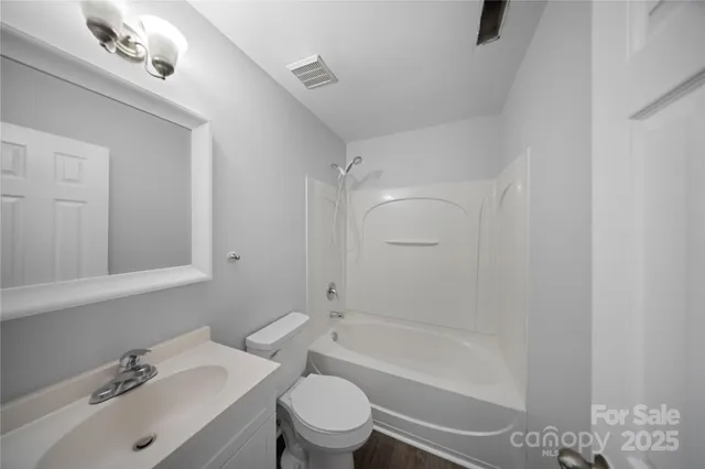 a bathroom with a sink mirror bathtub and toilet