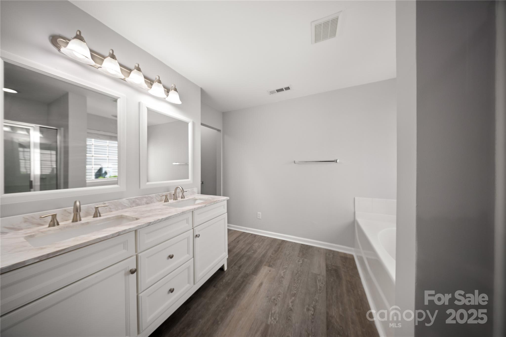 3056 Rocket Road Rock Hill, SC 29732 - Photo 18 of 33 a spacious bathroom with a double vanity sink and a mirror