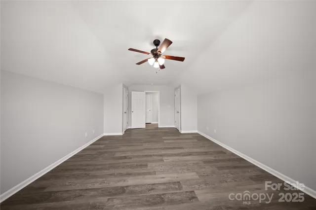 a view of empty room with ceiling fan