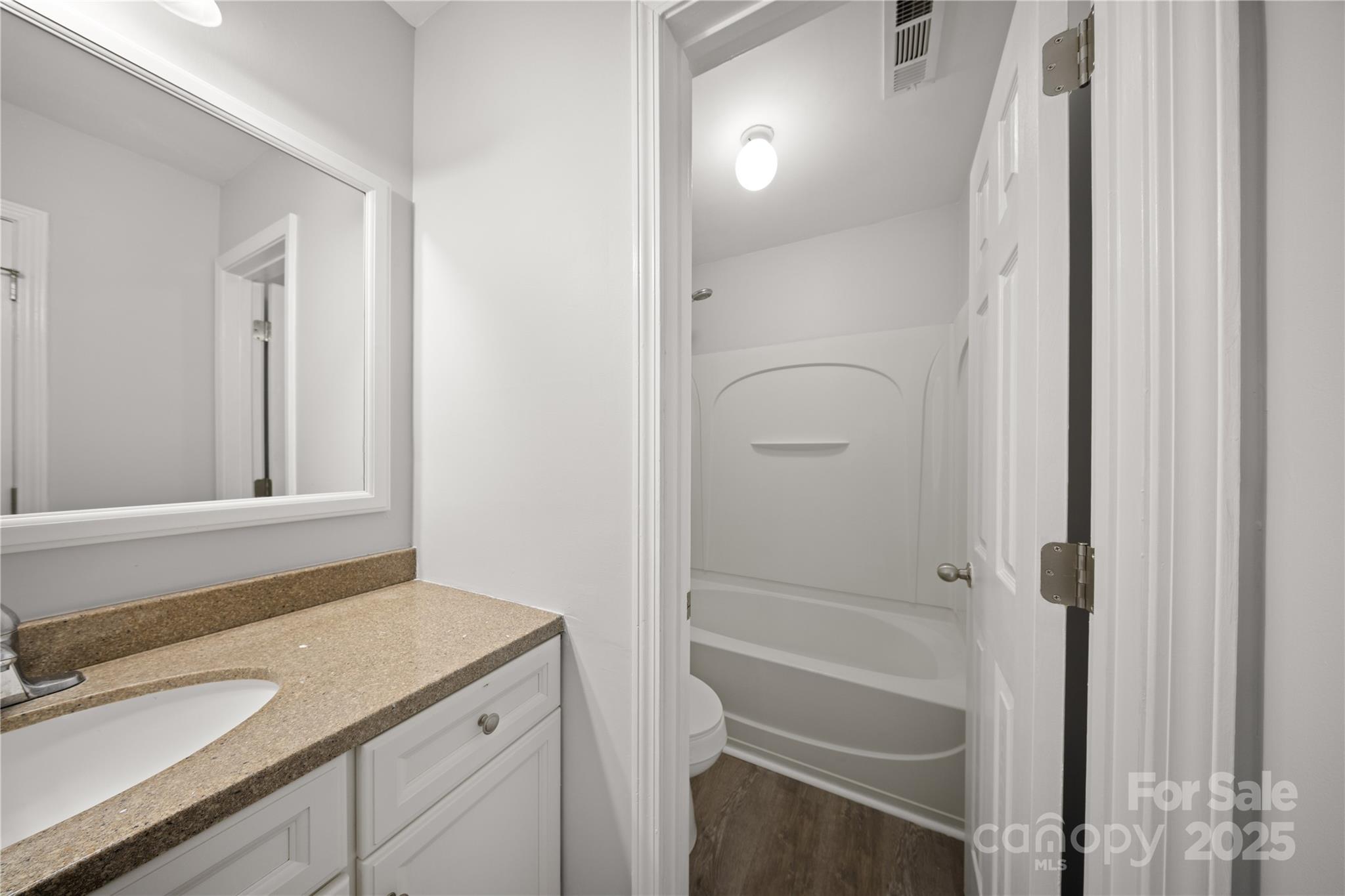 3056 Rocket Road Rock Hill, SC 29732 - Photo 27 of 33 a bathroom with a granite countertop sink mirror and a shower