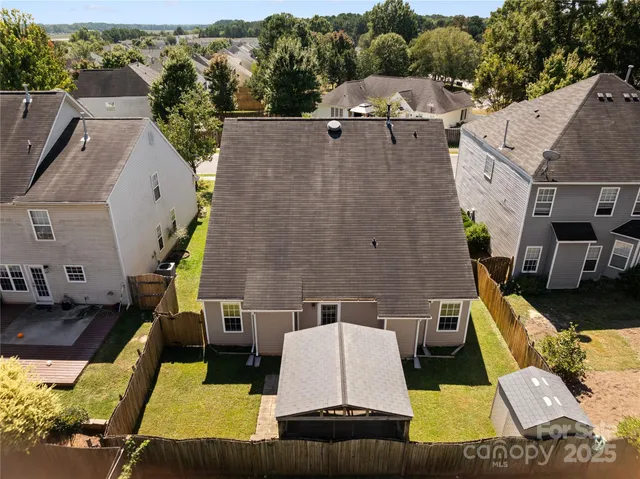 an aerial view of a house with a yard