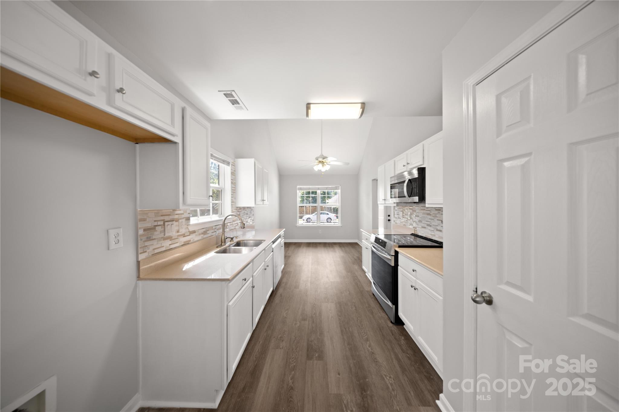 3056 Rocket Road Rock Hill, SC 29732 - Photo 9 of 33 a kitchen with granite countertop a sink stove refrigerator and cabinets