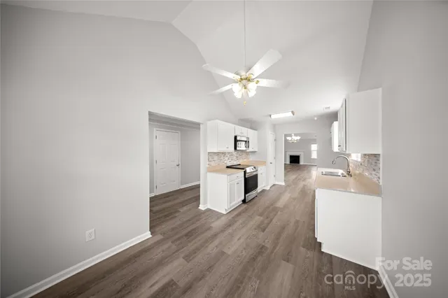 a view of a kitchen with a sink dishwasher a kitchen counter top space and cabinets