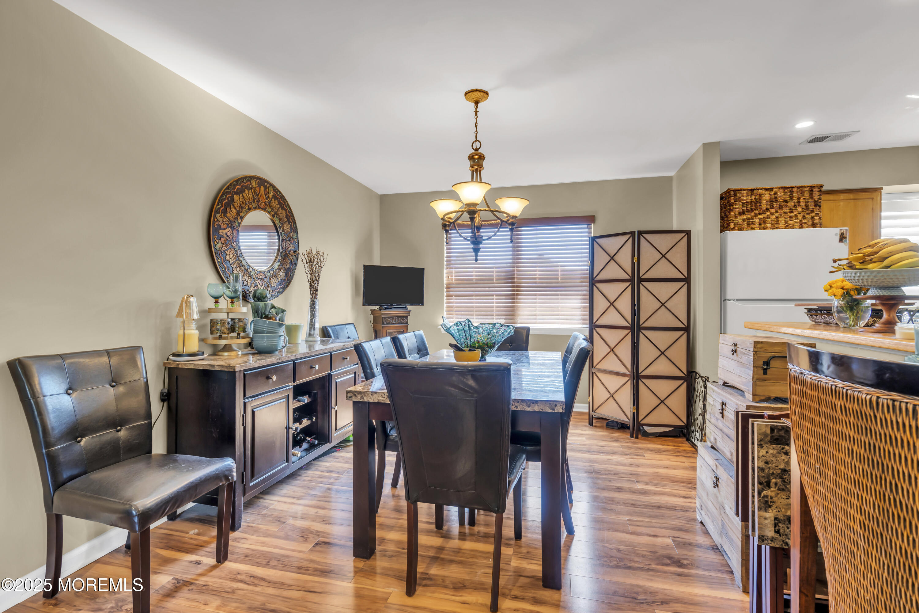 19 Sally Street Howell, NJ 07731 - Photo 8 of 31 a dining room with furniture a chandelier and wooden floor