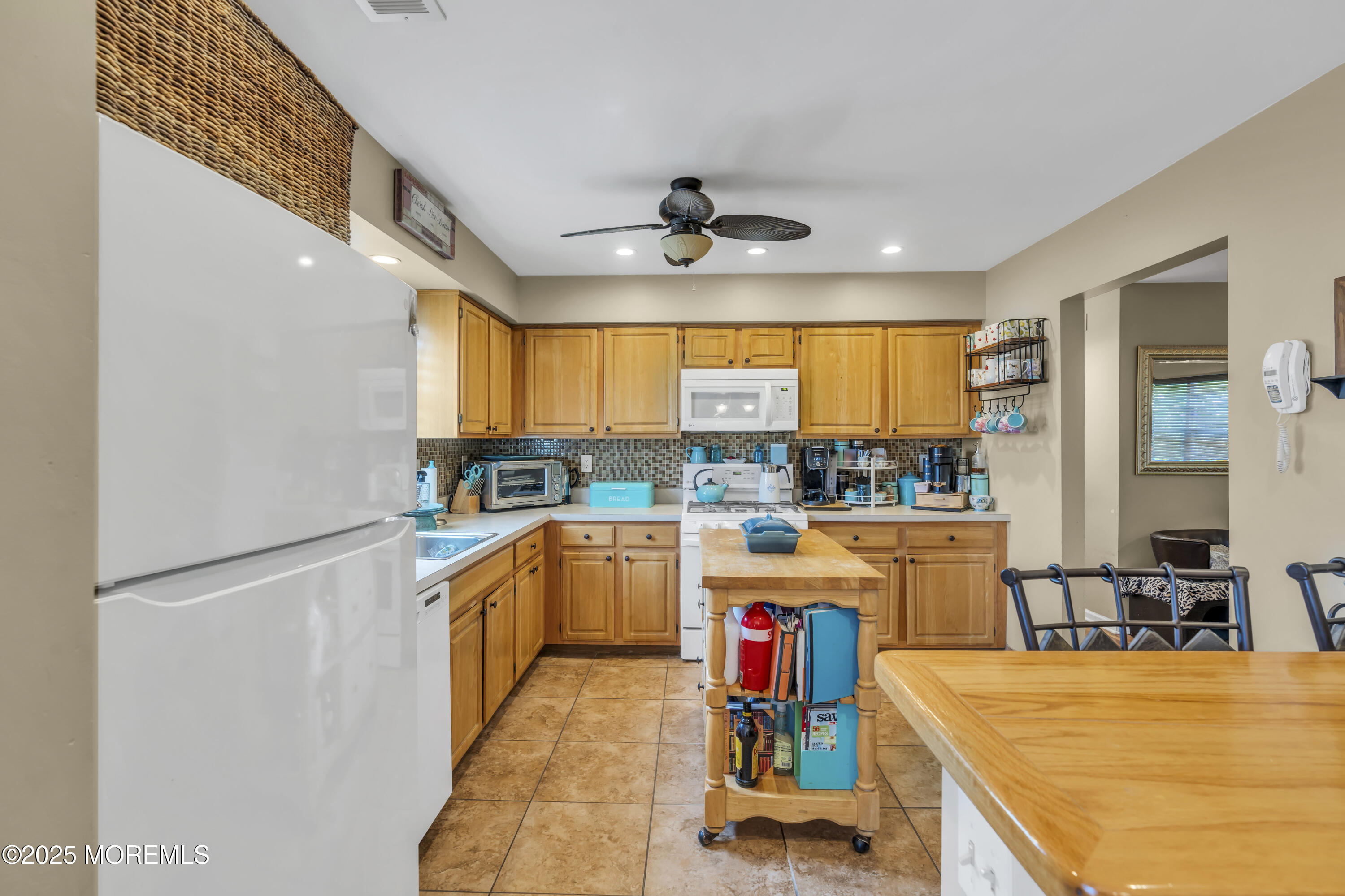 19 Sally Street Howell, NJ 07731 - Photo 9 of 31 a kitchen with stainless steel appliances a stove a refrigerator and a kitchen island