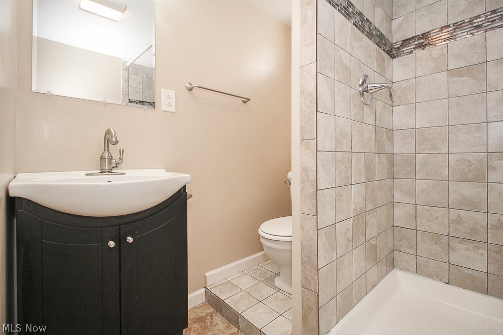 11988 Robson Road Grafton, OH 44044 - Photo 29 of 35 Lower level bath with ceramic tile shower with glass accent tiles.