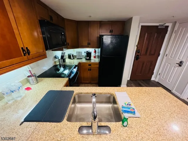 a kitchen with a sink and potted plant