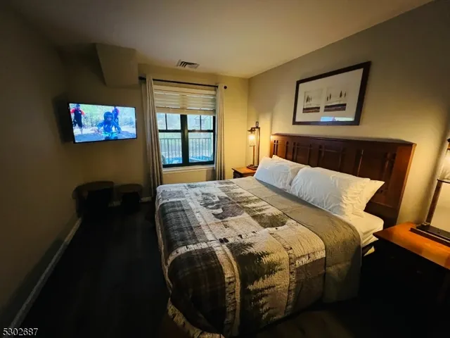 a bedroom with a bed and window